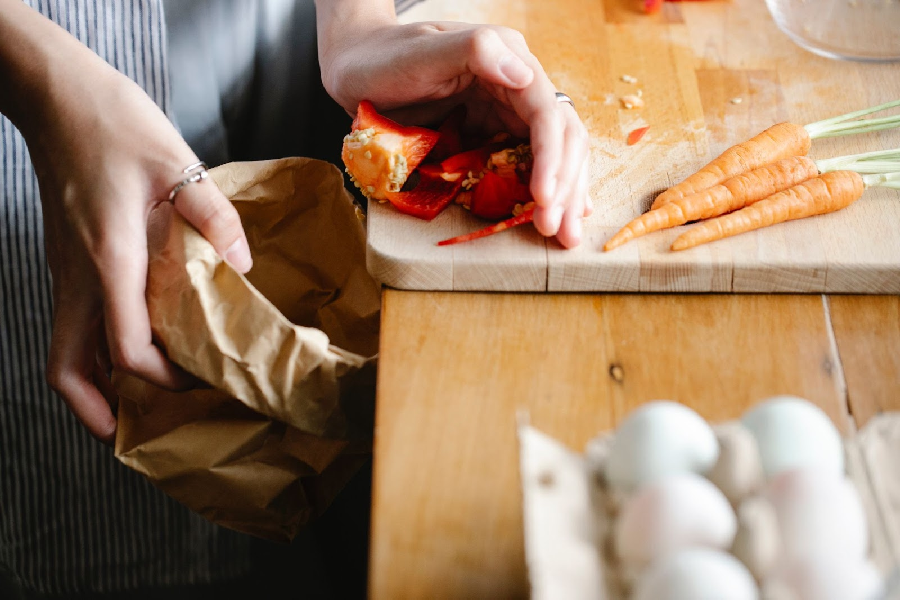 Woman throw away food in trash